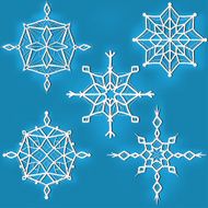 Set of ornate snowflakes against blue background
