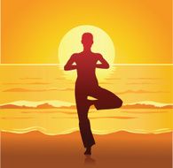 Practicing Yoga on the Beach at Sunset