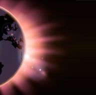 Sun rays burst over the globe
