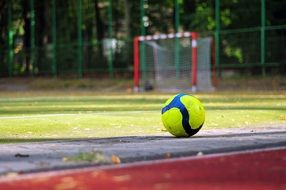 blue-yellow soccer ball on the field