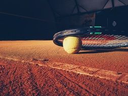 tennis racket and ball on court