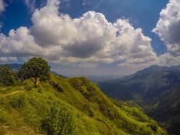 green mountains under the clouds