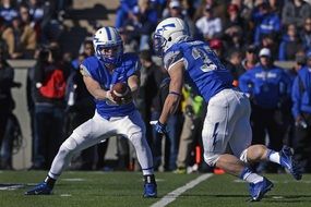 football players in blue uniform in american football
