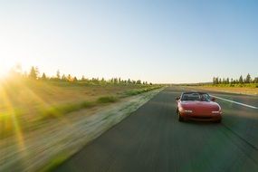 Sport car convertible mazda mx5 on the highway in the sunlight