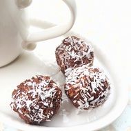 chocolate balls on tray beside of coffee mug