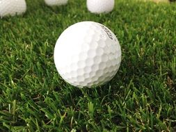 white golf balls on green grass