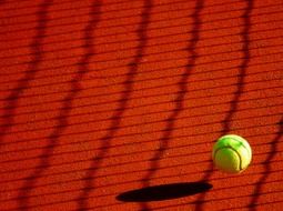 tennis ball on a red field