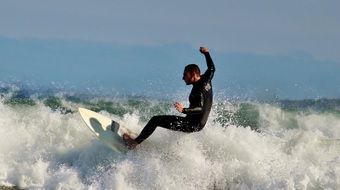 surfer is going in the sea waves