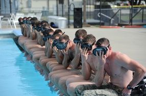 young people sit by the pool