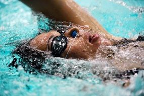girl swims in the pool