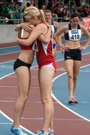 two runners are hugging on the treadmill