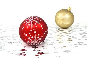 red and gold christmas balls on white table