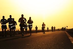 runners compete at sunset
