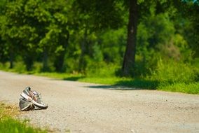 pair of sneakers on the road