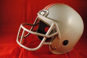 american football helmet on red fabric