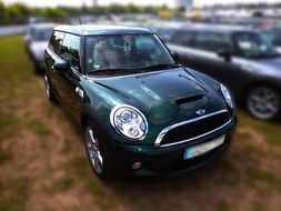 dark green mini cooper in the parking lot