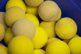 pile of used yellow tennis balls