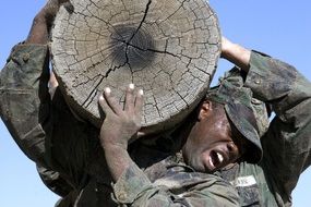 men carry a heavy log