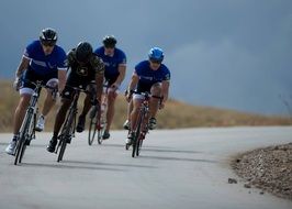 four male cyclists on road