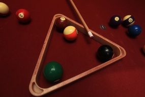 billiards equipment: rack, cue and balls on table