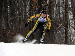 skier is crossing in yellow suit