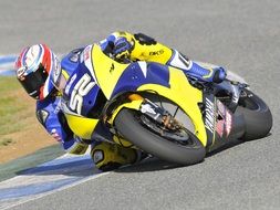motorcycle racer on a yellow-blue motorcycle