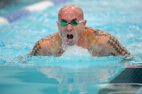 swimmer in green glasses at the pool