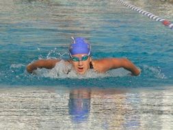 swimmer in blue swimming cap in the pool