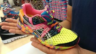 running shoes in human hands