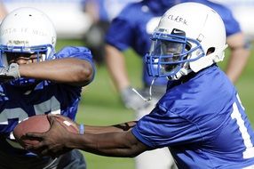 soccer player with a ball in american football