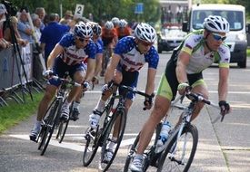 cyclists ride along the road