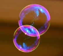 two colorful soap bubble together