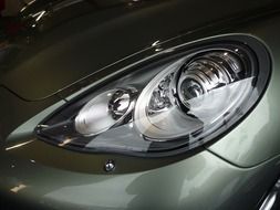 headlight of a silver sports car close-up