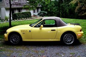 yellow convertible near the house