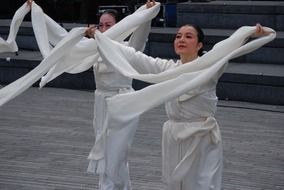 dancers in white suits