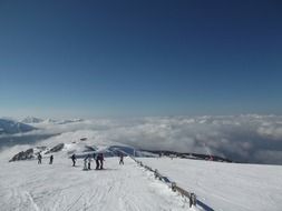 skiers on a slope in chanrousse in france