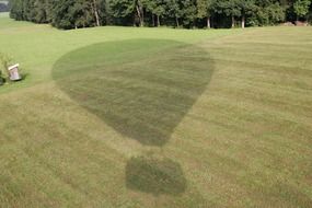 hot air balloon shadow on the grass