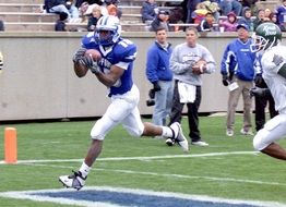 football player runs with the ball
