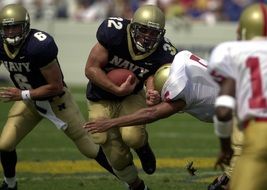 football players catch the ball in american football