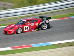 red sports car driving on the highway