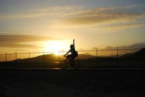 man on bike on sunset background