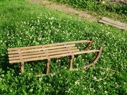 wooden sled stands on the grass