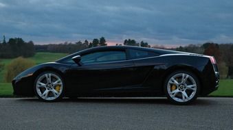 black luxury sports car on the road