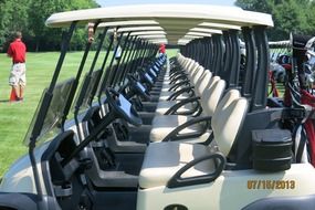 row of golf carts on lawn