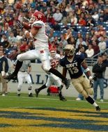 football player jumps for the ball