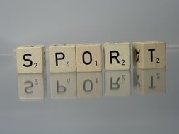 scrabble cubes on a mirror table