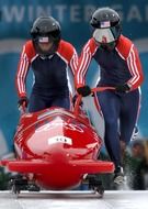 winter olympic games, two women pushing bobsled