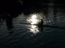 man on a canoe at night