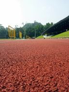 brown running track in the stadium close up