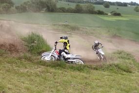 motorcyclists ride downhill
